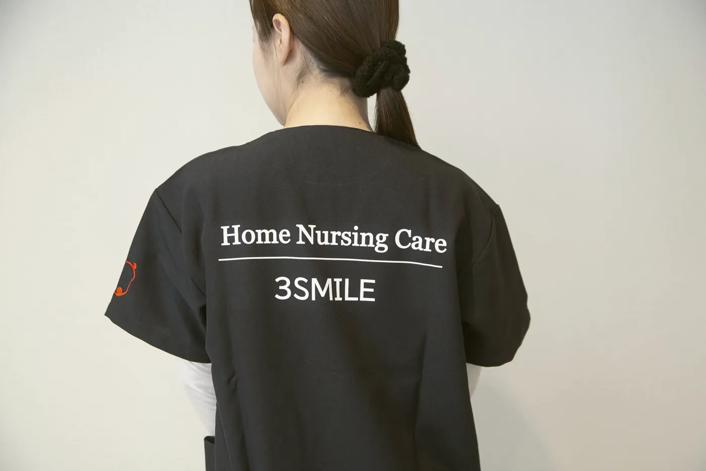 「Home Nursing Care 3SMILE」と書かれた制服の背中